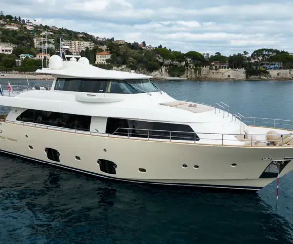 Luxury motor yacht Ferretti Custom Line Navetta 26 'La Pausa' in clear waters with scenic coastal backdrop.