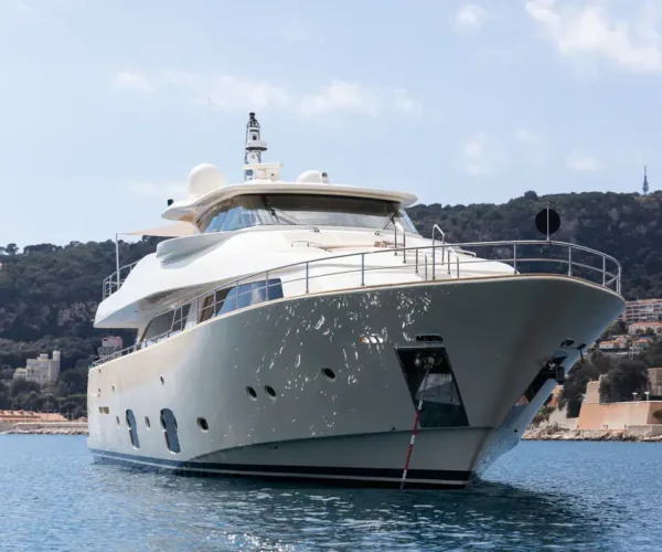 Elegant luxury yacht Ferretti Custom Line Navetta 26 'La Pausa' in turquoise waters against a scenic hillside backdrop.