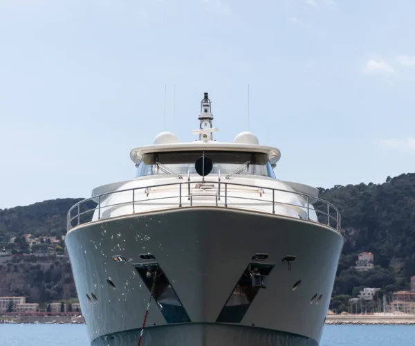 Elegant luxury yacht Ferretti Custom Line Navetta 26 'La Pausa', moored on calm sea with scenic hills in the background.