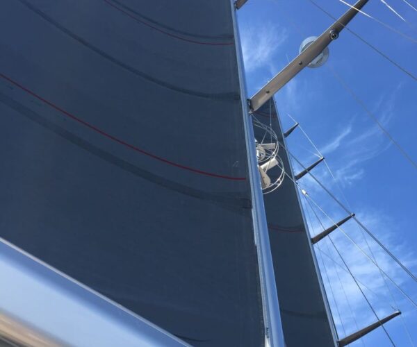 Close-up of yacht sail and rigging on a clear day.
