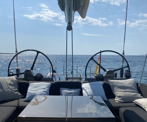 Elegant yacht deck with seating area and open sea background.