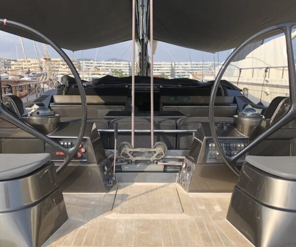 Luxury yacht helm station with dual steering wheels, navigation controls, and modern dashboard.